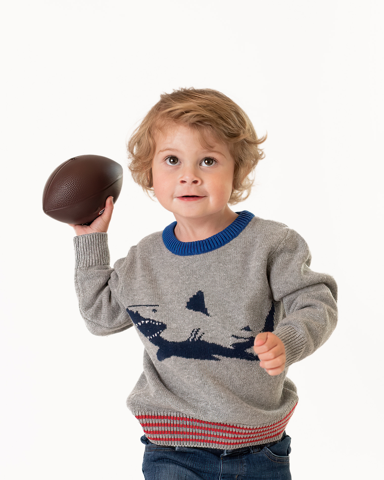 Little boy in grey sweater holding a football Houston Pediatricians