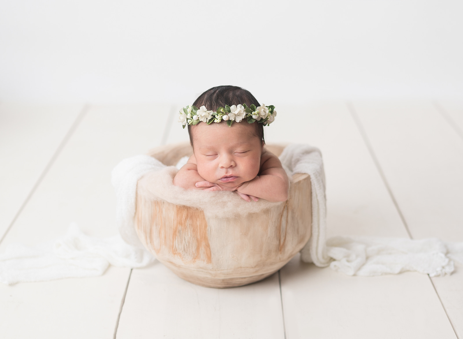 newborn girl with flower crown sleeping in a bowl Houston baby shower venue