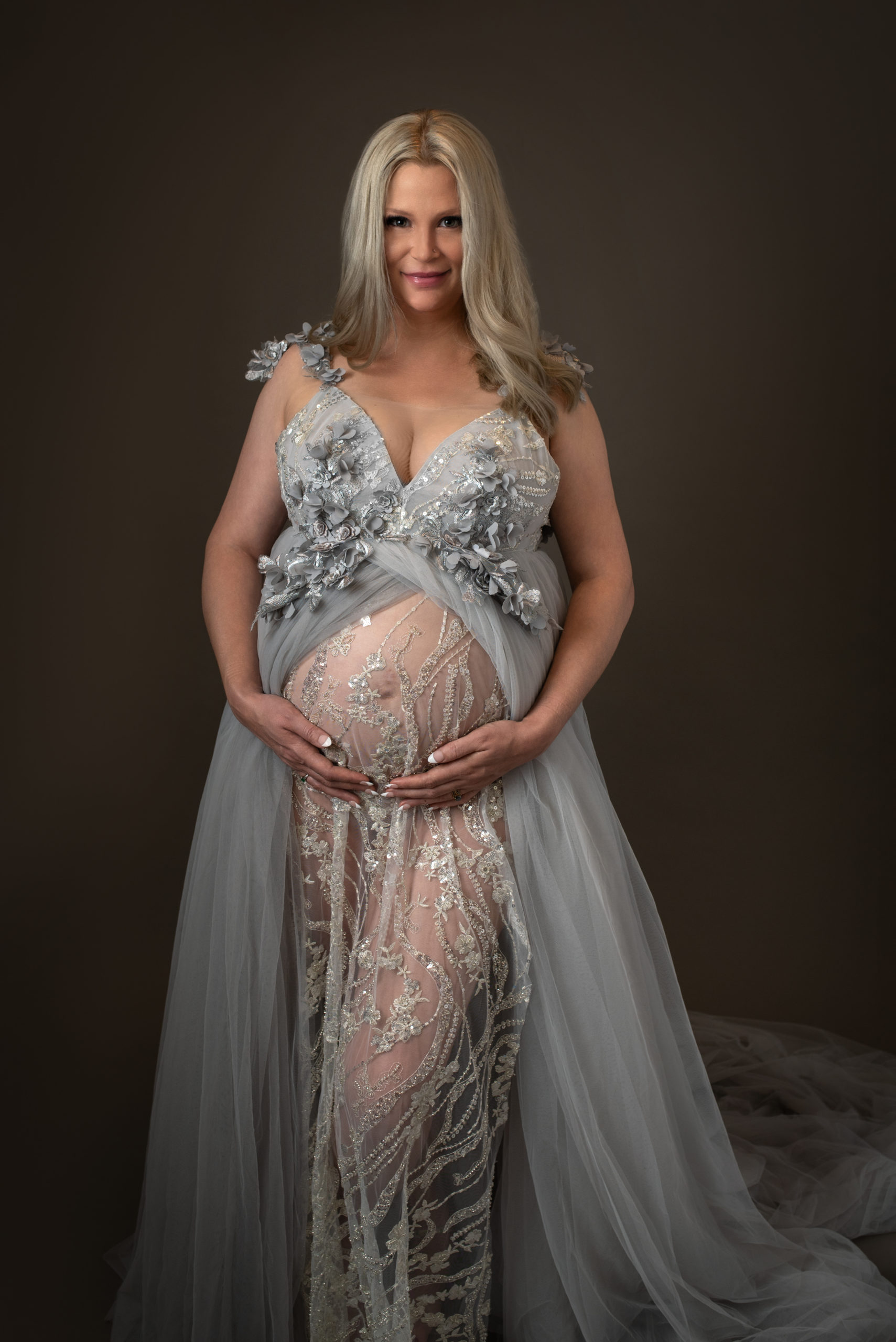 Mom to be in grey maternity gown showing off her bump UTMB Labor and Delivery