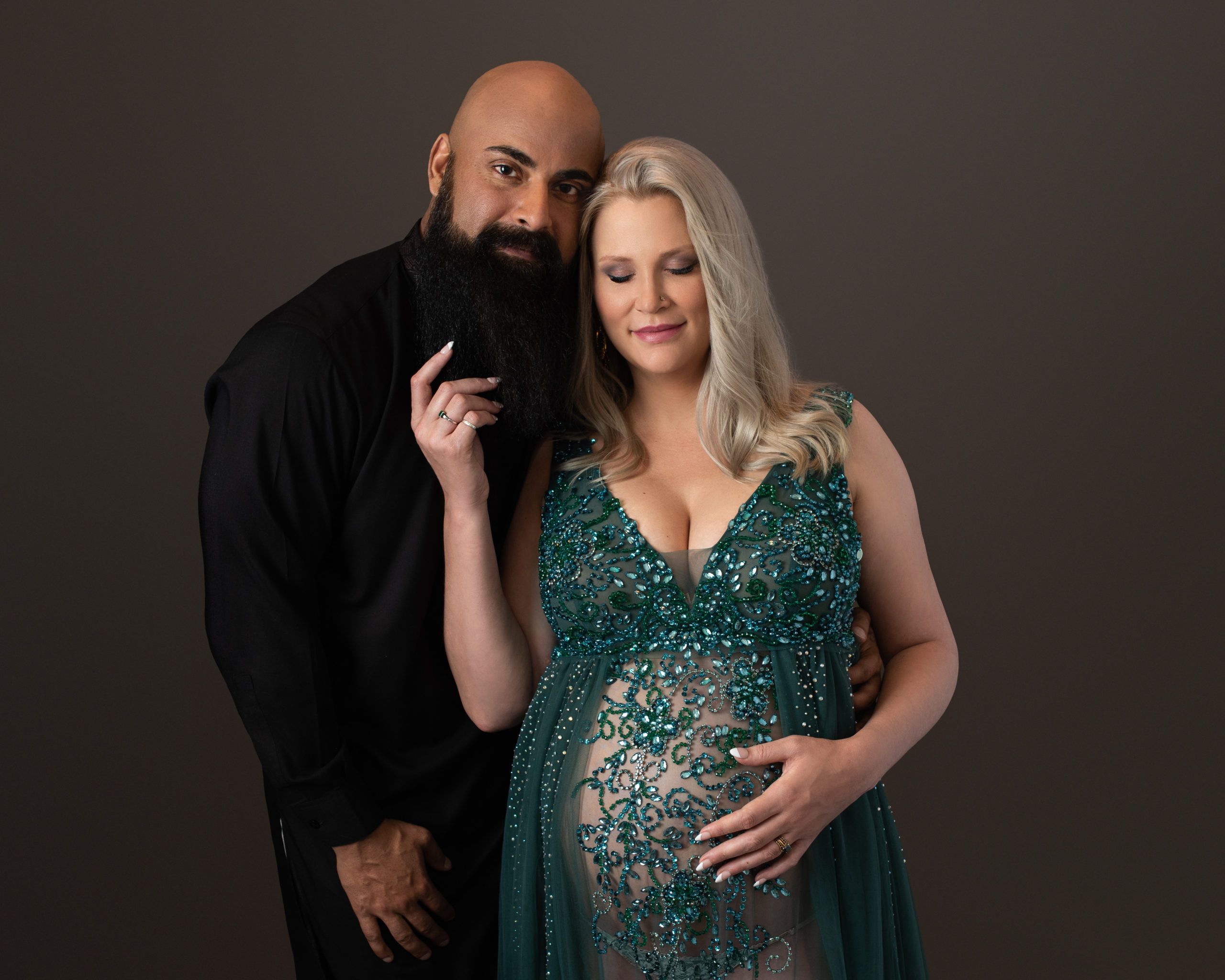 new parents awaiting the arrival of their little one while wearing black and green