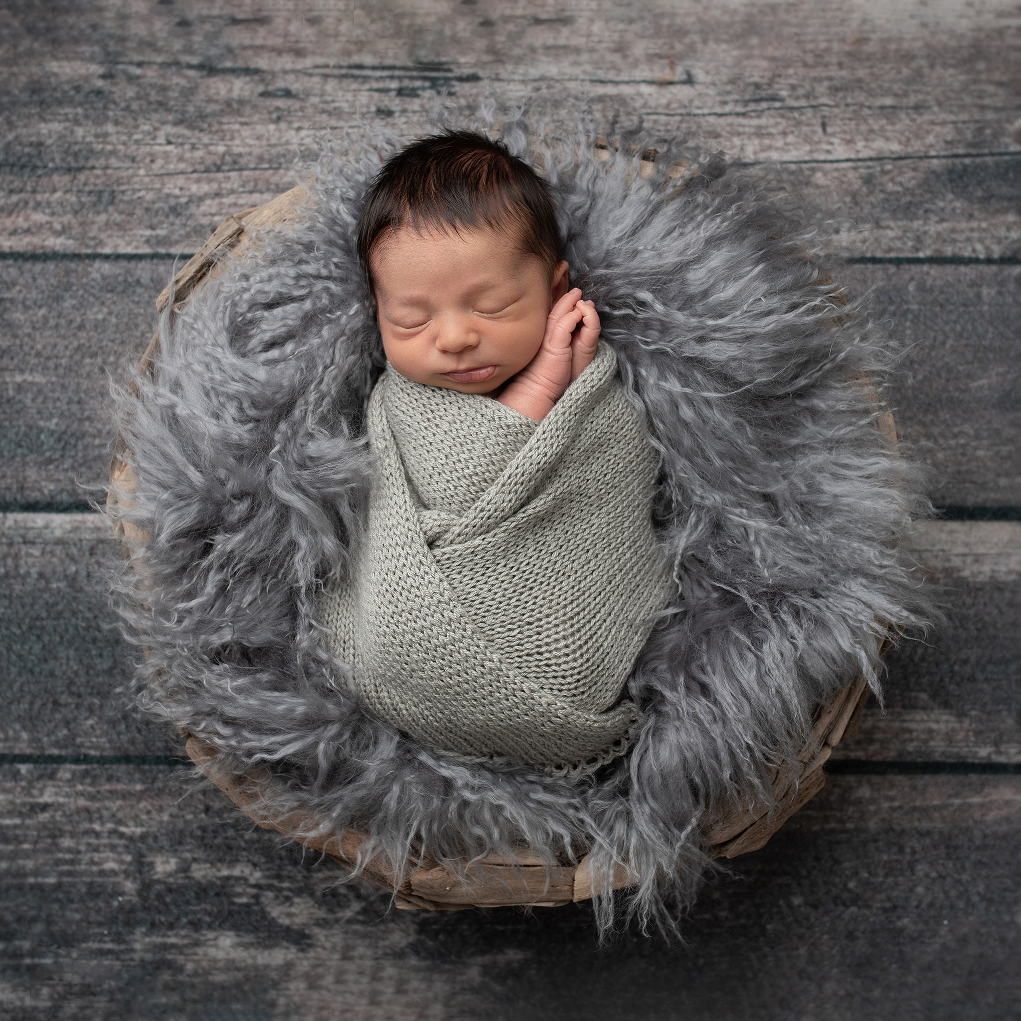 newborn baby wrapped in grey Little Cottontail