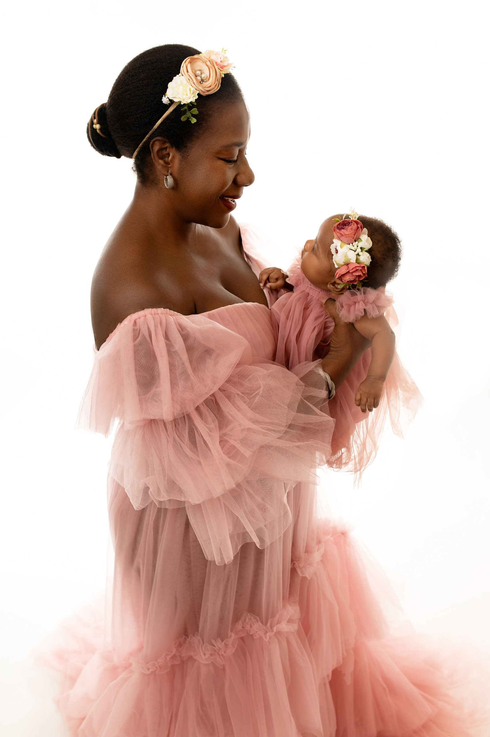 new mom in pink tulle dress holding her newborn baby Kandiland league city