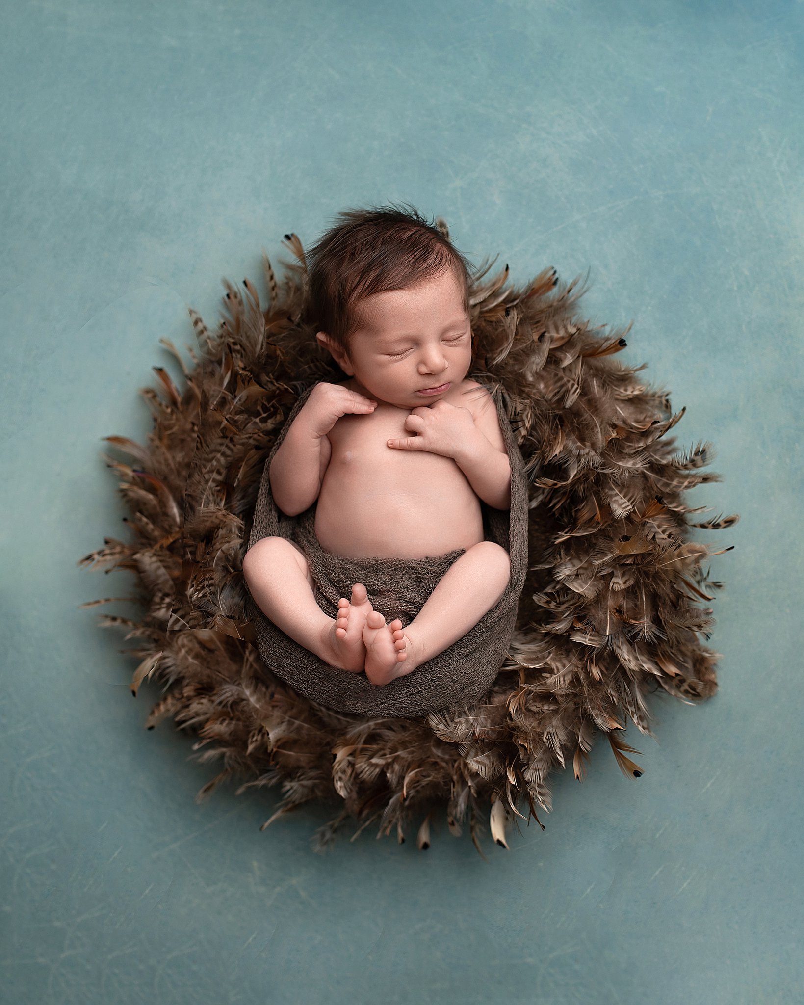 Newborn baby. sleeps in a feather bed in a studio indoor playground league city